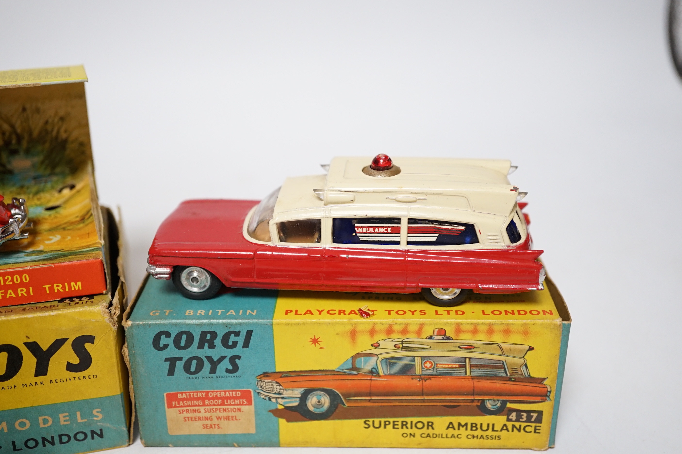 Three Corgi Toys including (256) Volkswagen 1200 in East African safari trim (with rhino and inner display stand), (437) Cadillac Superior Ambulance, both boxed, together with an unboxed Commer three-quarter ton police v